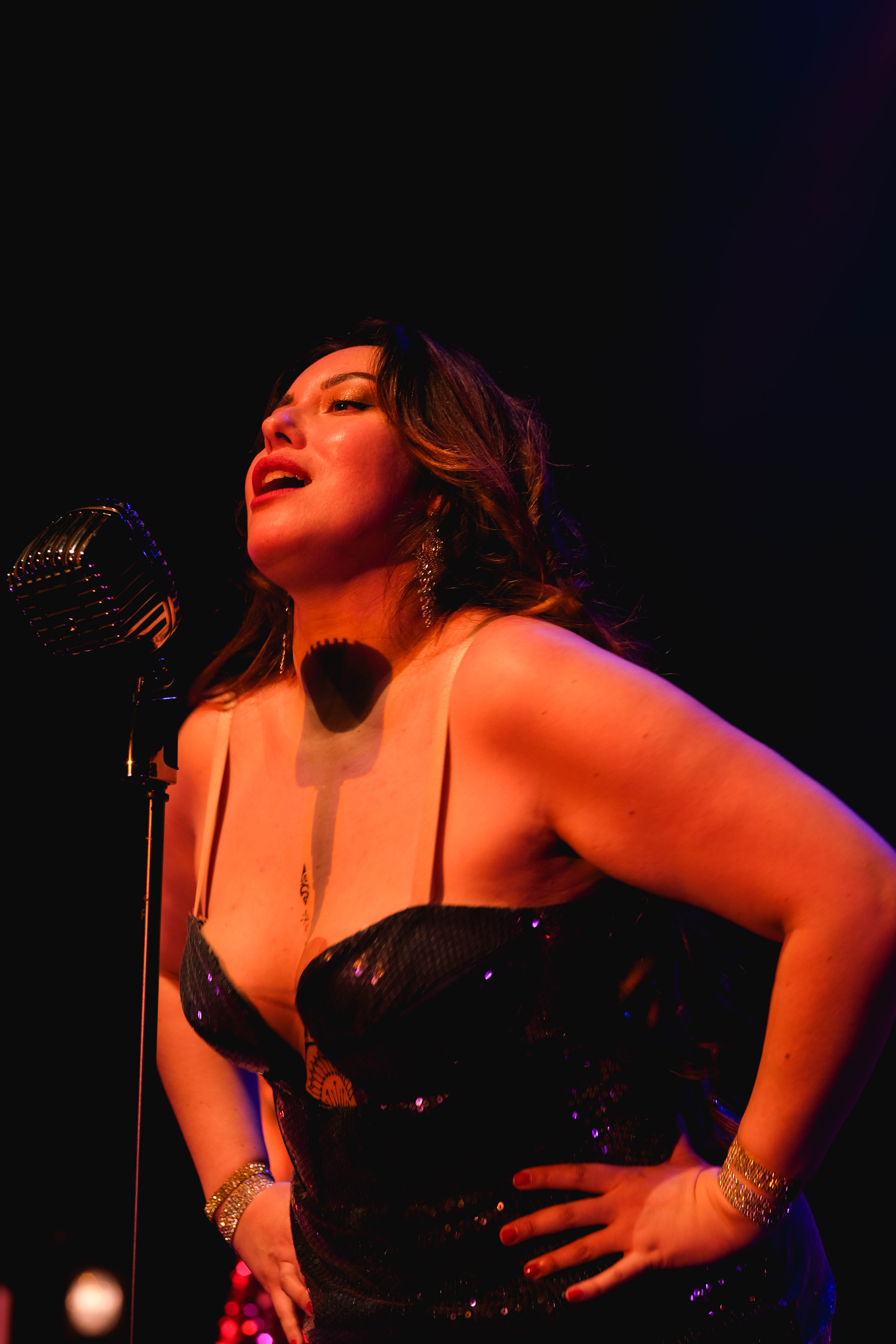 Woman singing in blue shining dress.