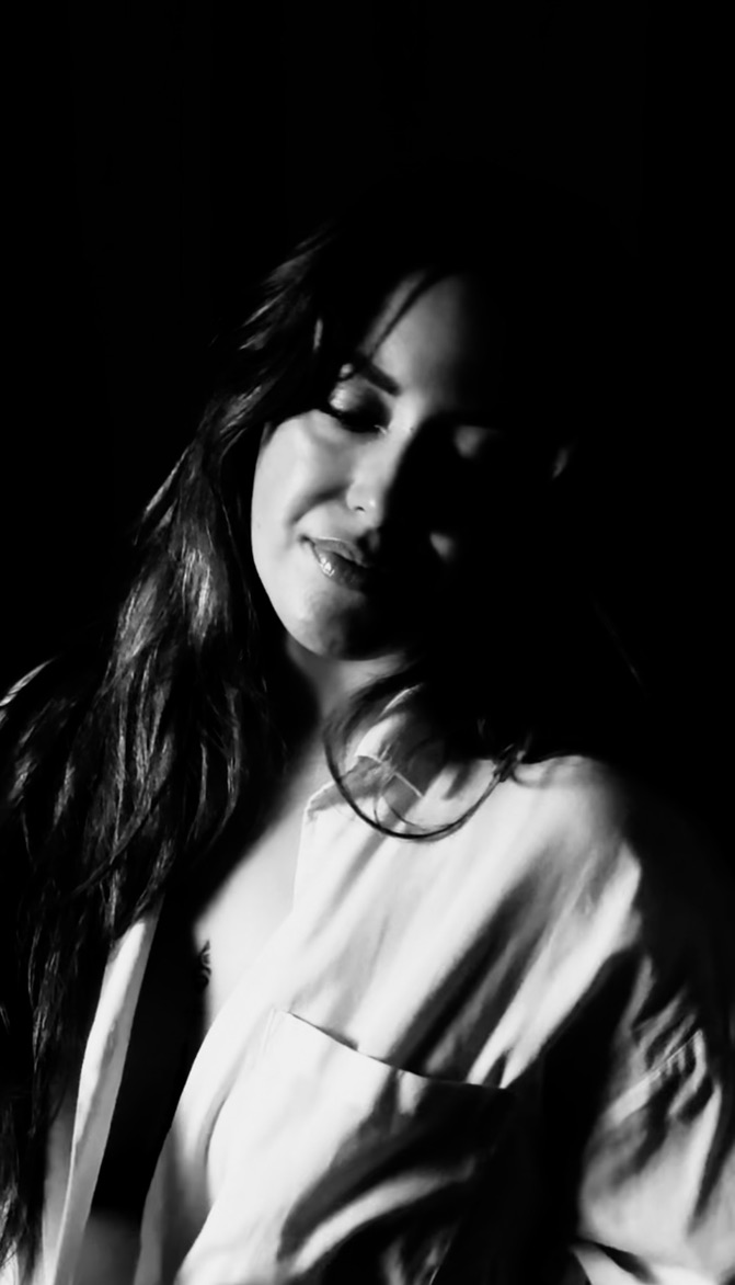 Close up of a woman wearing a white shirt.