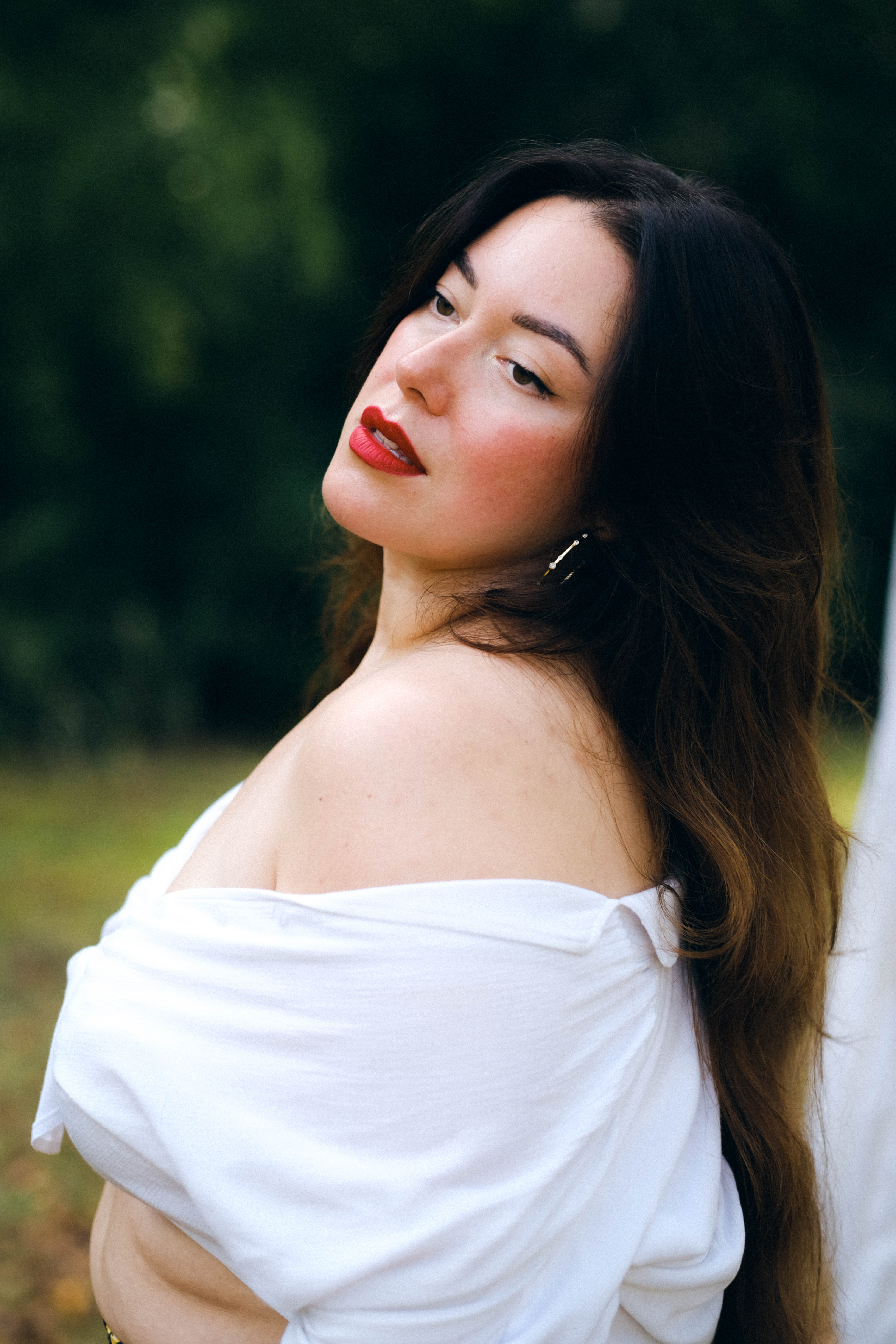 Profile of a woman wearing a white croc top.